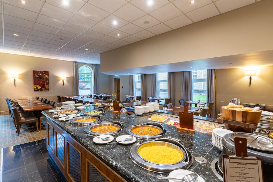 Dining area with a self-service station featuring appetising, exposed meals.